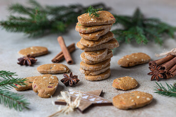 Danish spicy butter cookies with candied fruits, cinnamon sticks and anise, light background....