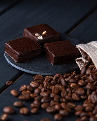 coffee beans are scattered on the table and sweets lie nearby