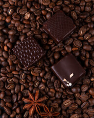 coffee beans are scattered on the table and sweets lie nearby