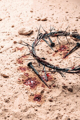 Crown of thorns and bloody nails on ground. Good Friday, Passion of Jesus Christ. Christian Easter holiday. Top view, copy space. Crucifixion, resurrection of Jesus Christ. Gospel, salvation