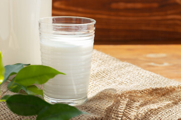 Glass cup of milk on table close up