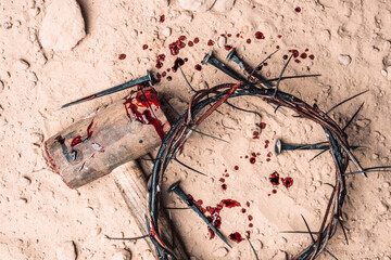 Good Friday, Passion of Jesus Christ. Crown of thorns, hammer, bloody nails on ground. Christian Easter holiday. Top view, copy space. Crucifixion, resurrection of Jesus Christ. Gospel, salvation