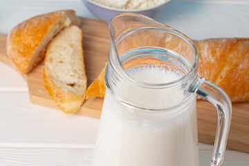 Milk, bread and cottage cheese on table