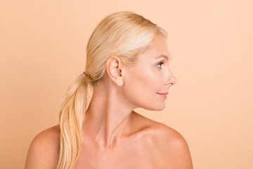 Profile side view of middle aged woman look copyspace show her beauty modern technics anti dar spots procedure isolated over pastel color background