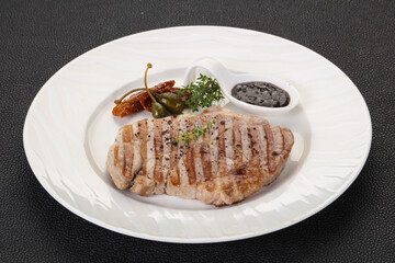Grilled pork steak with pepper sauce