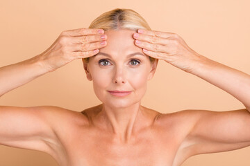 Photo of natural beauty aged lady naked shoulders touch forehead perfect skin look mirror anti age...