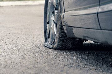 flat car tire close up, punctured wheel