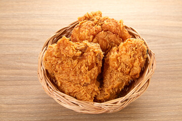 crispy fried chicken in basket on wood table
