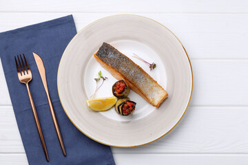 Roasted salmon fillet in plate on white wooden table