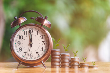 Money coin stack growing graph with alarm clock to profit concept investment business and finance