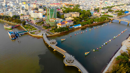 Top view aerial view love bridge or Ninh Kieu quay of downtown in Can Tho City, Vietnam with development buildings, transportation, energy power infrastructure