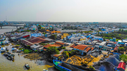 Obraz premium Aerial view of Cai Rang floating market, Can Tho, Vietnam. Cai Rang is famous market in mekong delta, Vietnam. Tourists, people buy and sell food, vegetable, fruits on boat, ship