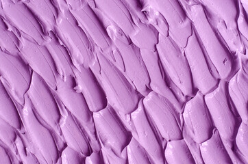 Obraz premium Purple clay (alginate face mask, body wrap, hair conditioner) texture close up, selective focus. Abstract lavender background with brush storkes.