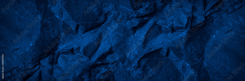 Wall mural abstract blue background. toned monochrome stone rock texture background. web banner. wide. dark blu