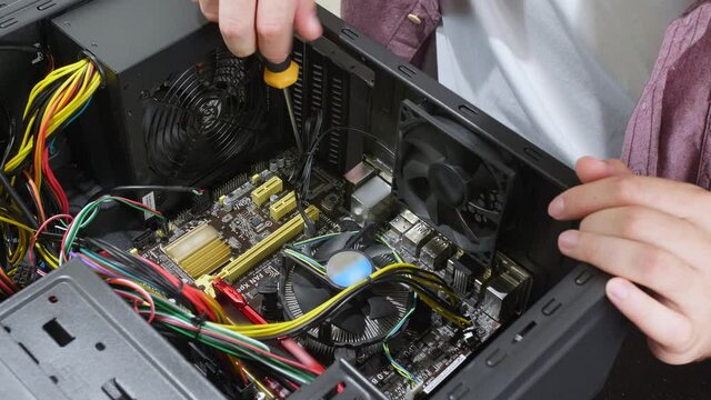 Technician repairing computer in service center, closeup
