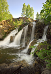 Fototapeta na wymiar Belovsky waterfall in spring - vertical