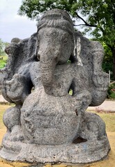 Fototapeta premium Hindu God deity statue. Ancient sandstone carved historical Hindu God sculptures in the temple walls.