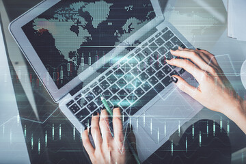 Double exposure of woman hands working on computer and forex chart hologram drawing. Top View. Financial analysis concept.