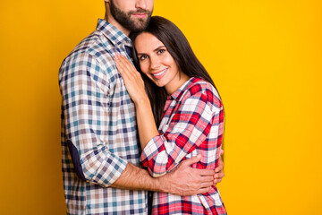 Photo portrait of girl laying on man's chest hugging isolated on vivid yellow colored background