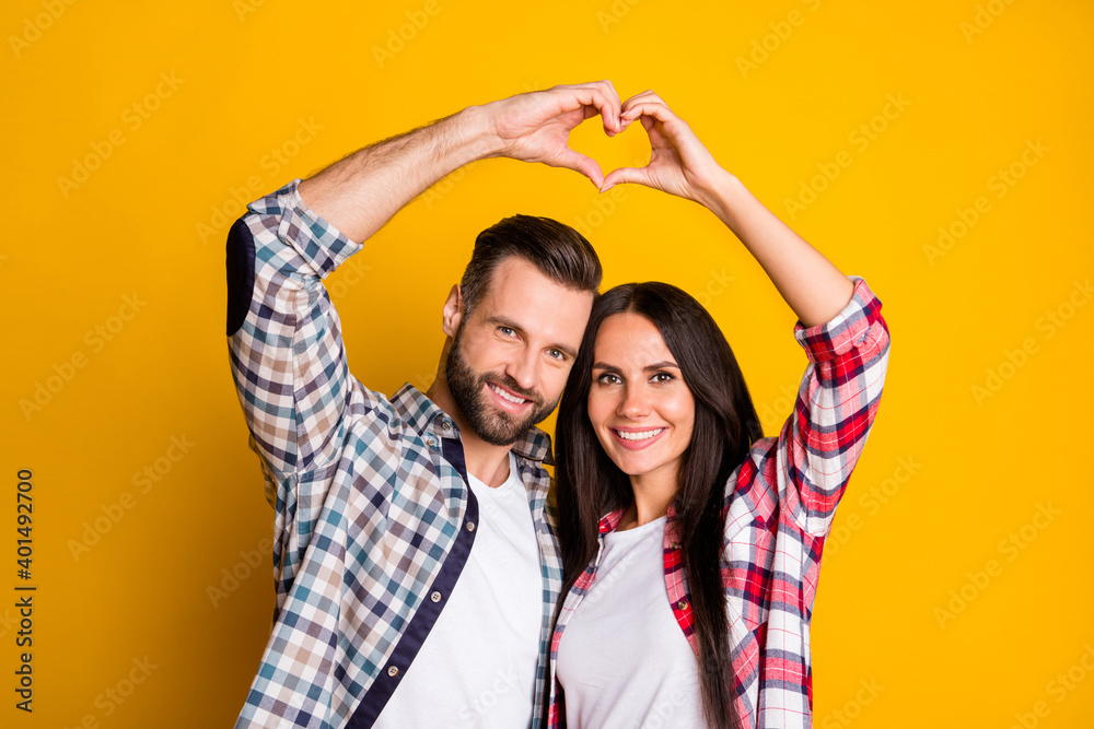 Sticker Portrait of lovely cheery couple showing up heart symbol shape idyllic isolated over bright yellow color background