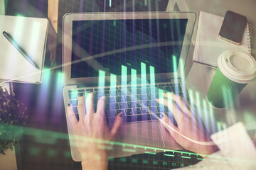 Obraz na płótnie Canvas Double exposure of woman hands typing on computer and forex chart hologram drawing. Stock market invest concept.