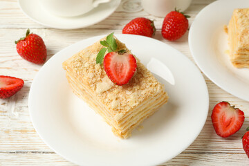 Concept of lunch with Napoleon cake on white wooden background