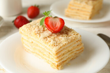 Concept of lunch with Napoleon cake on white wooden background