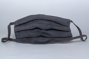 Black medical protective mask on grey background