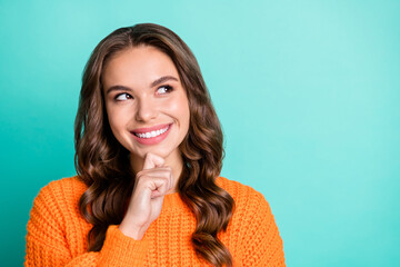 Photo of young girl happy smile dream dreamy think guess look empty space isolated over turquoise...