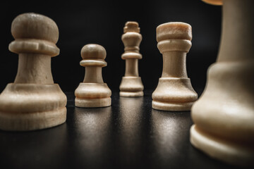 Chess game with chess pieces against black background
