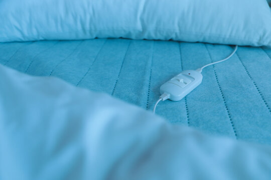 Bed with electric heating pad, closeup view