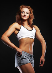 Fototapeta na wymiar Picture of beautiful sporty muscular woman isolated on black background