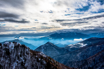 Fototapeta na wymiar snow-capped alpine peaks in the clouds two