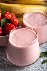 Fresh smoothie with banana and strawberry in the glasses. Healthy breakfast or snack.
