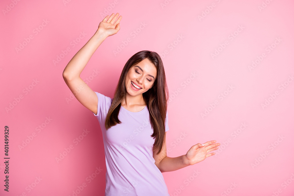 Sticker Photo portrait of beautiful female student dancing at party with closed eyes isolated on pastel pink color background