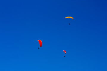 Fototapeta na wymiar View of three Paraglider flying high over the lake lucerne in switzerland
