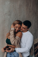 Photoshoot of a young couple in love. The solitude of a guy and a girl. Studio photography. Black background.