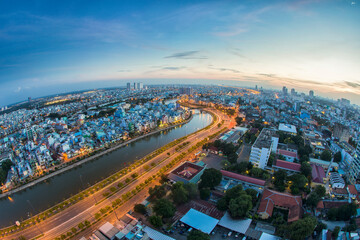 Obraz premium Beautiful night city, cityscape of Ho Chi Minh city, Vietnam, modern futuristic architecture nighttime illumination, luxury traveling concept.