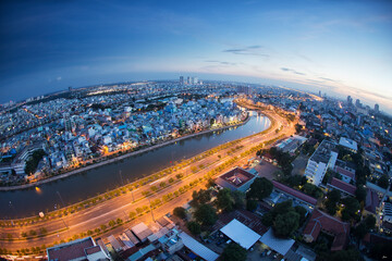 Fototapeta premium Beautiful night city, cityscape of Ho Chi Minh city, Vietnam, modern futuristic architecture nighttime illumination, luxury traveling concept.
