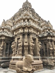 Temple tower against blue sky background. Ancient Hindu temple with sandstone carved historical Hindu God and animal sculptures.