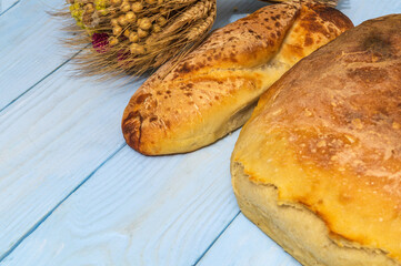 Bakeds loafs of Ukrainian national bread on blue table