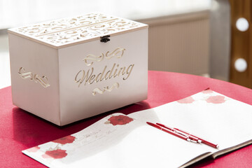 Wedding box. Vintage box for money at the wedding. Handmade . White box with the inscription "wedding" stands on the table. Transparent wedding box for money, gifts and greetings card © Marianna