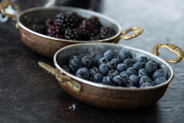 Forest berries. Bilberries and blackberries.