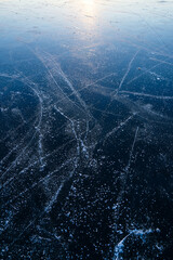 Texture of ice. Frozen lake at pink sunset. Beautiful nature background