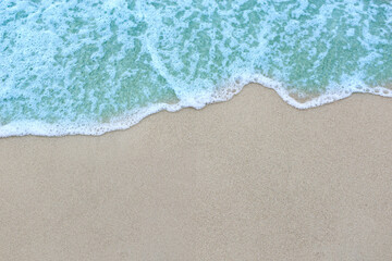 Naklejka na ściany i meble Beautiful ocean waves on the sandy beach Abstract style nature background pastel tones