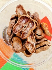 cracked peanut shells in a glass at the beach. 