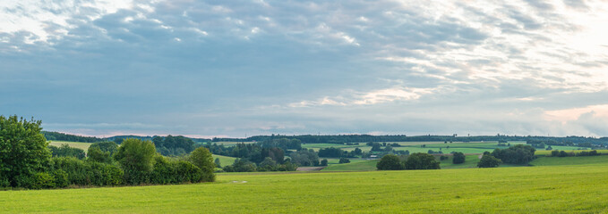 Landscape panorama. Sky with clouds. Green meadow. Gorgeous rural scene. Large open space.