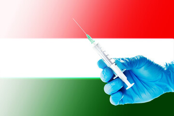 Hungary Flag Blurred Background Covid-19, Corona, Selective focused on Syringe Injection