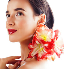 young pretty brunette real woman with red flower amaryllis close up isolated on white background. Fancy fashion makeup, bright lipstick, creative Ombre manicured nails