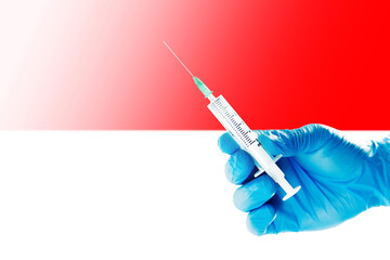 Indonesia Flag Blurred Background Covid-19, Corona, Selective focused on Syringe Injection